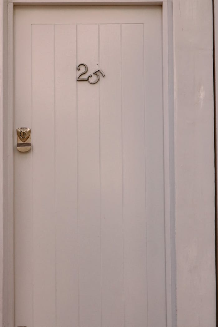 services-02 Close-up of a white door featuring a number 25, showcasing modern simplicity.